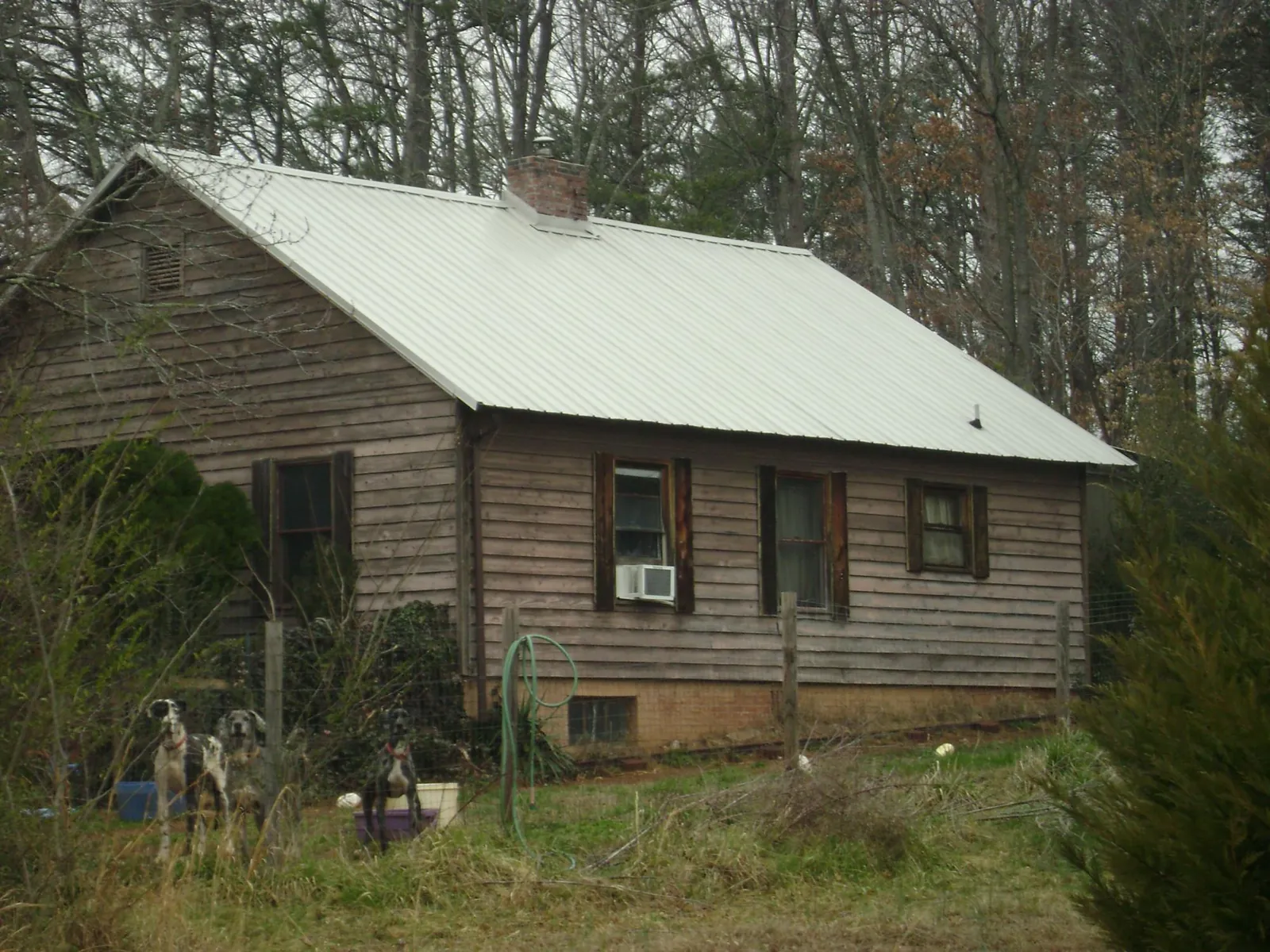 White metal roof on an old wood sided farmhouse, from a Metal Roof Installation job in Hull